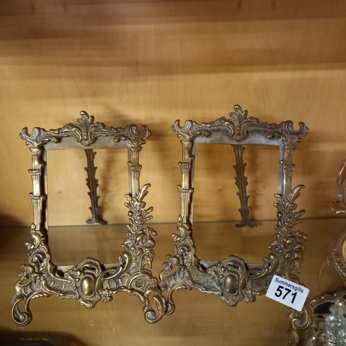 571 - A pair of ornate brass photo frames