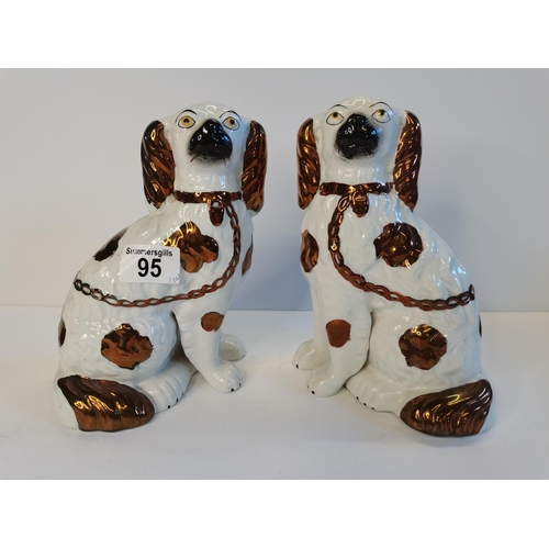 95 - A pair of rare Staffordshire dogs with separated paws