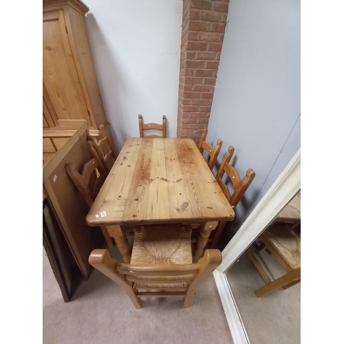 1107 - Pine kitchen table 137cm x 92cm and 6 reed seated chairs