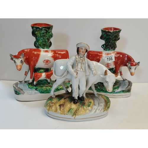 198 - Pair of Staffordshire cow figures plus one