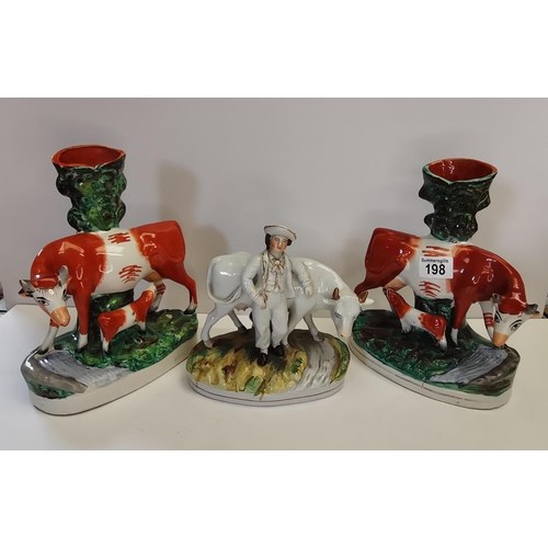 198 - Pair of Staffordshire cow figures plus one