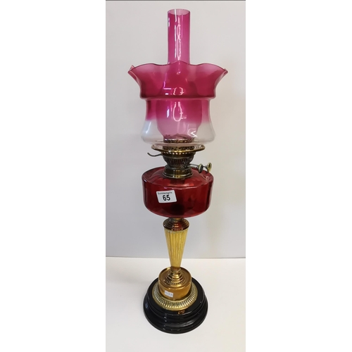 65 - Victorian Oil lamp with Cranberry coloured glass 68cm good condition