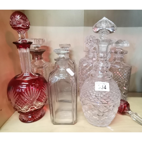 334 - A collection of cut Glass Decanters including one Cranberry Glass