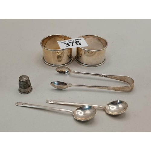 376 - Silver items including napkin rings, sugar tongs and spoons 48grams