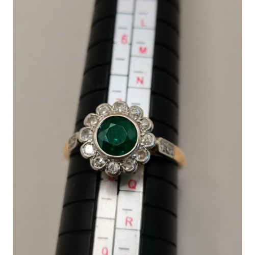 409 - 18ct Gold and platinum ring with Emerald centre stone and surrounded with Diamonds size Q