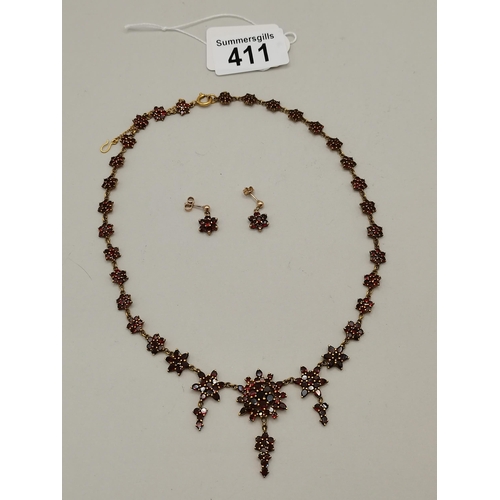 411 - 9ct Gold necklace and matching earrings with red stones