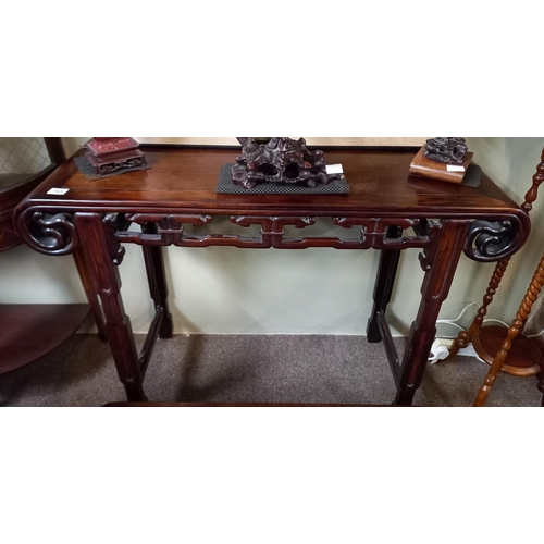 753 - A Chinese hardwood altar table with shaped ends and side carvings