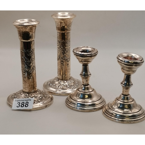 388 - A pair of Chester silver candlesticks and another pair of candlesticks