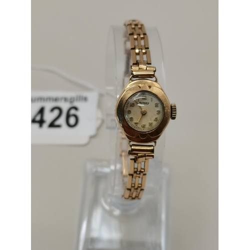 426 - 9ct gold ladies wrist watch with rolled gold strap working