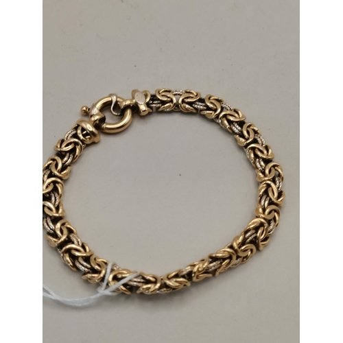 479 - A 14k gold bracelet highly decorative with loop faster 14g