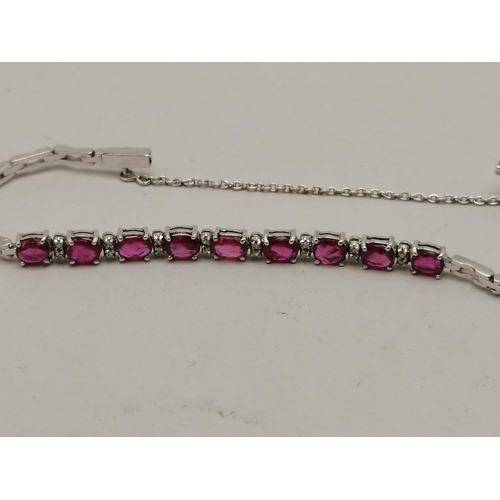 491a - 18k white gold and ruby bracelet and matching earrings