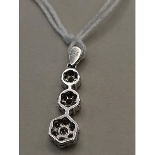 521 - 10k white gold pendant with 3 floral diamond drops made up of 7 diamonds to each