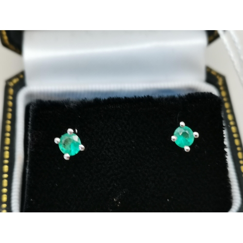 523 - A pair of single stone Emerald stud earring set in 18ct White gold