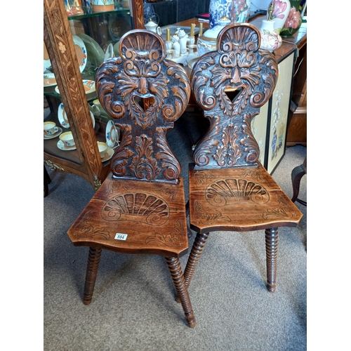 594 - Pair of greenmail oak carved hall chairs with bobbin turned legs ( split on both seats )