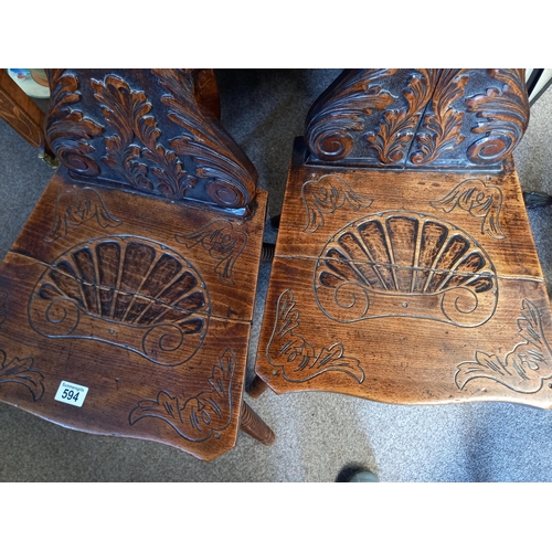 594 - Pair of greenmail oak carved hall chairs with bobbin turned legs ( split on both seats )