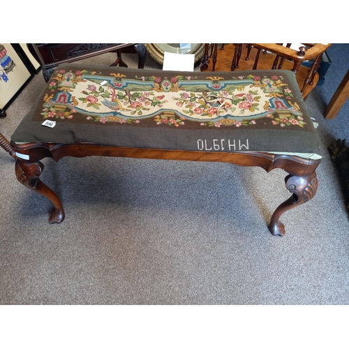 596 - An Antique walnut dressing stool with Queen Anne style legs and tapestry seat