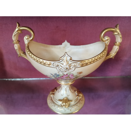 665 - Royal Worcester Blush Ivory Boat shaped twin handled pedestal vase. W23cm x H20cm x D10cm