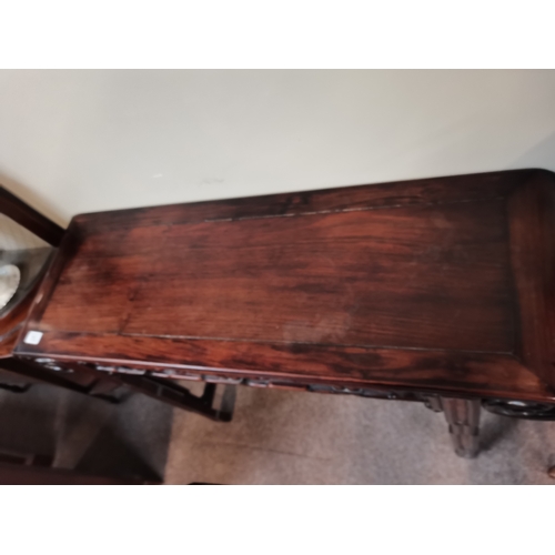 753 - A Chinese hardwood altar table with shaped ends and side carvings