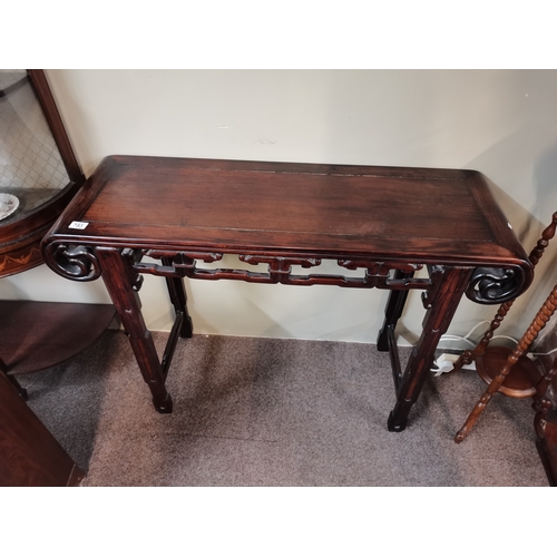 753 - A Chinese hardwood altar table with shaped ends and side carvings