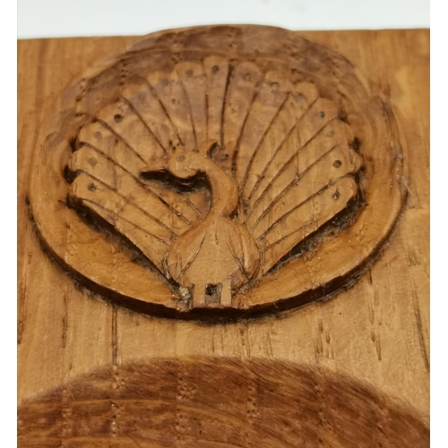 115F - Two Yorkshire oak ashtrays, of typical form, one with carved peacock signature and the other with th... 