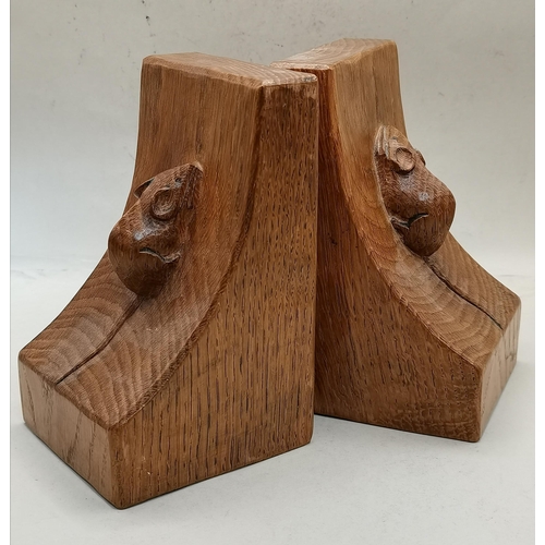 126 - Robert Thompson, a pair of Mouseman oak book ends, rectangular, lightly adzed, the curved sides each... 