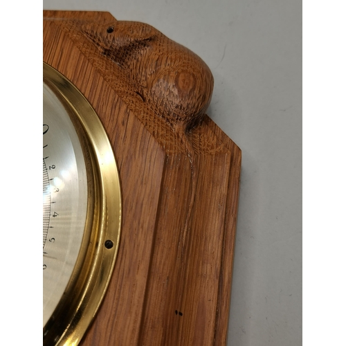 132 - Robert Thompson, a Mouseman oak-mounted barometer, octagonal, inset with a brass twin diaphragm dopp... 