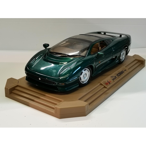 15 - A Maisto Jaguar XJ220 (1992) model car, scale 1:12, on display plinth. Plinth 47.2cm by 25.4cm