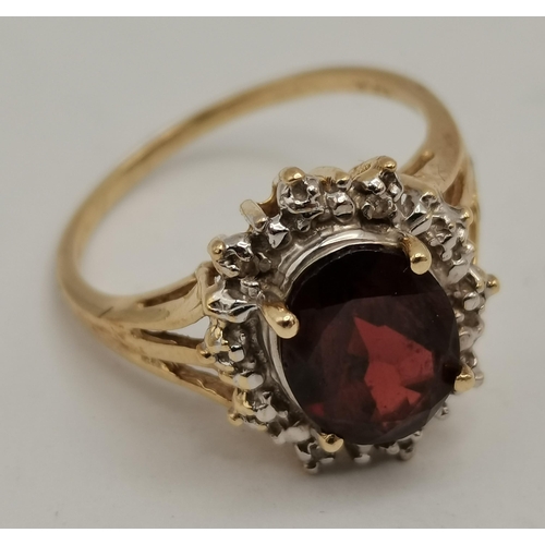 342c - Garnet & Diamond oval cluster ring set in 14ct gold comprising of a deep red oval Garnet to the cent... 