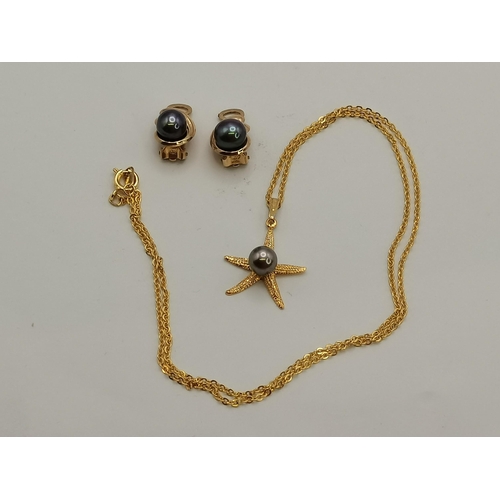 350B - A starfish yellow metal and black pearl necklace with clip earrings en suite; together with a lady's... 