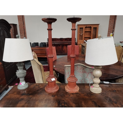 907 - A pair of grey table lamps and a pair of wooden 80cm high church candlesticks