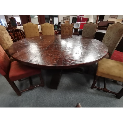 909 - A 1.8m diameter Eric Gott of Pickering hand made burr oak circular dining table with cross stretcher... 