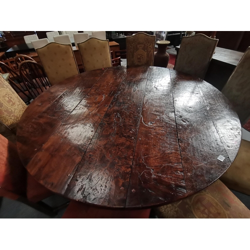 909 - A 1.8m diameter Eric Gott of Pickering hand made burr oak circular dining table with cross stretcher... 