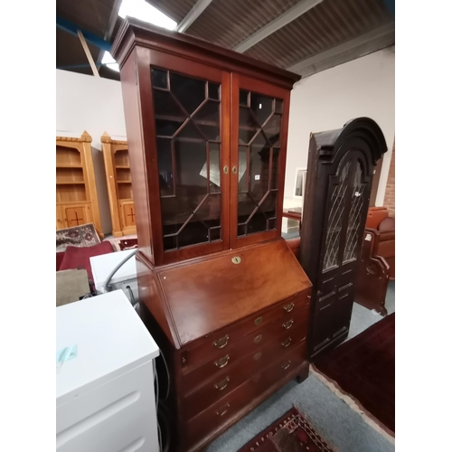 911 - A Georgian mahogany bureau bookcase with astral glazed top. the interior with Sheraton shell inlaid ... 