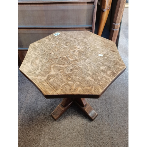 690 - Robert Thompson, a Mouseman oak coffee table, the adzed octagonal top raised on a cruciform base, wi... 