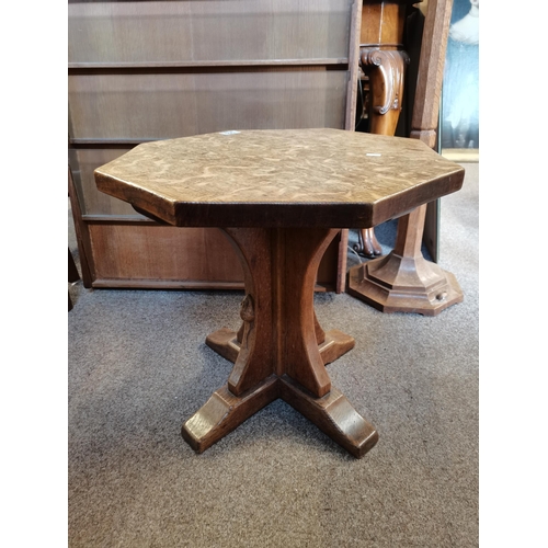 690 - Robert Thompson, a Mouseman oak coffee table, the adzed octagonal top raised on a cruciform base, wi... 