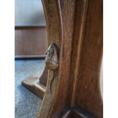 690 - Robert Thompson, a Mouseman oak coffee table, the adzed octagonal top raised on a cruciform base, wi... 