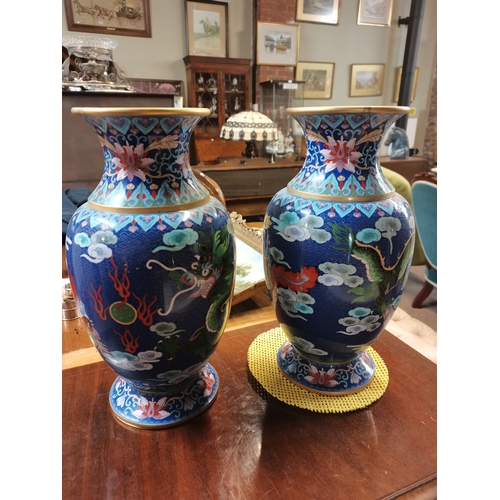 697 - A large pair of Chinese cloisonné vases, each decorated with a green five-toed dragon chasing a flam... 