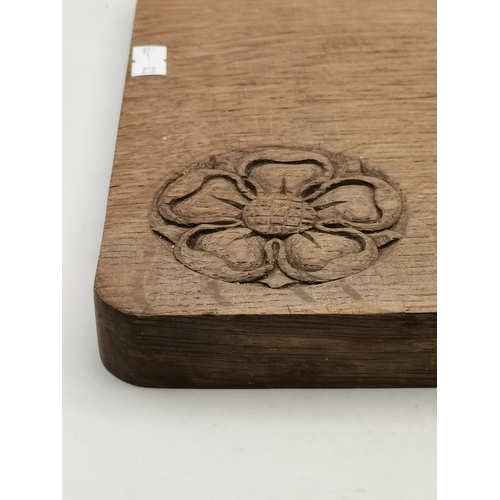 150 - A Yorkshire oak breadboard, rounded rectangular, with knife en suite, with carved Yorkshire Rose. 24... 
