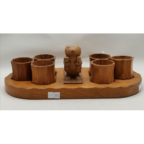 152 - Colin Almack, a Beaverman oak napkin ring stand, oval, with carved standing beaver holding a hammer ... 