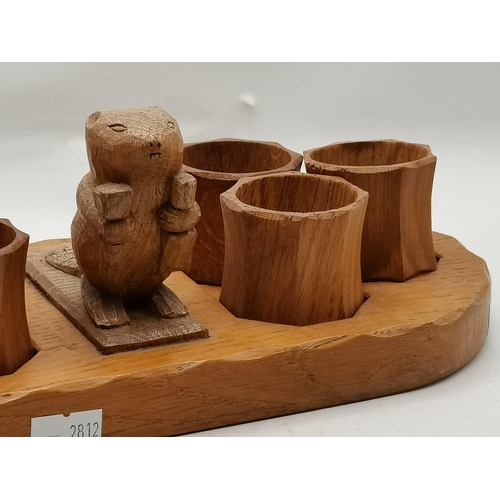 152 - Colin Almack, a Beaverman oak napkin ring stand, oval, with carved standing beaver holding a hammer ... 