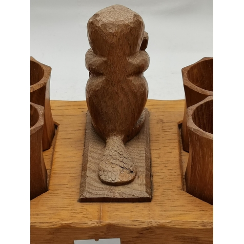 152 - Colin Almack, a Beaverman oak napkin ring stand, oval, with carved standing beaver holding a hammer ... 
