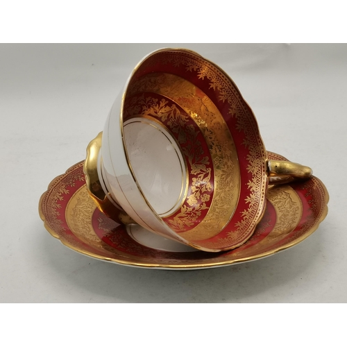 170 - A Royal Stafford red band with gold pedestal tea cup and saucer