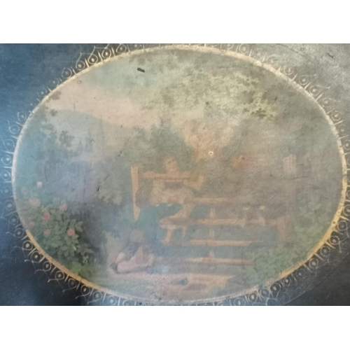 23 - A large oval papier-mâché tray, painted to the centre with children playing on a gate in a woodland ... 