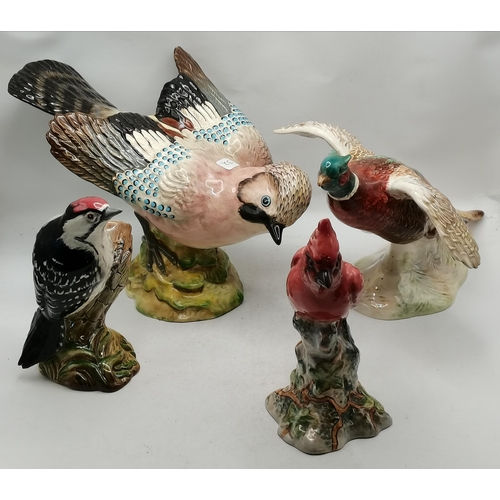 27B - A group of four Beswick bird models comprising Pheasant Taking Off, model no. 850; Jay, model no. 12... 