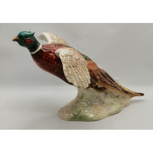 27B - A group of four Beswick bird models comprising Pheasant Taking Off, model no. 850; Jay, model no. 12... 