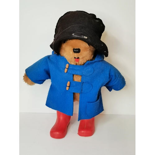 47 - Paddington Bear, a vintage standing teddy bear with blue duffel coat, black hat and red wellington b... 