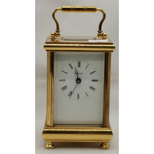 5 - A mahogany arch-top mantel clock by Comitti, London, mid-20th Century, the 4-inch cream circular dia... 