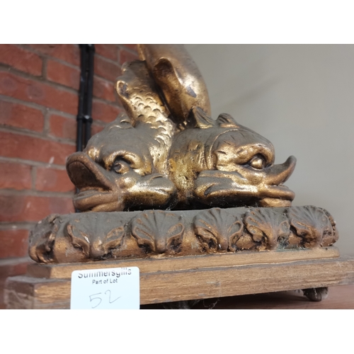 52 - A gilt wooden figural table lamp, as three stylised dolphins to a triangular base with shell rim. 44... 