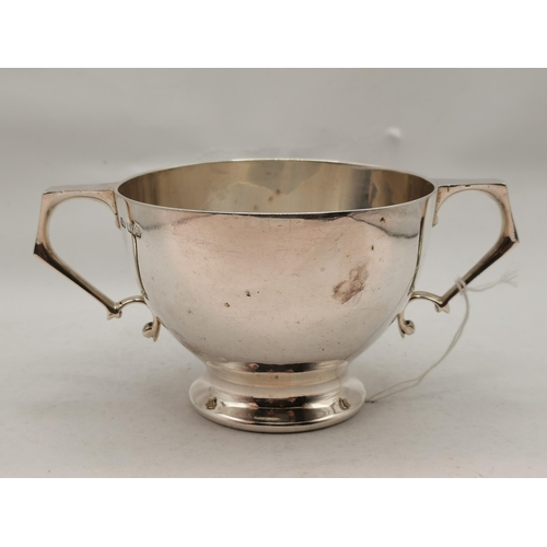 331 - A George V Irish silver twin-handled sugar bowl by Reid & Sons, Dublin 1916, the plain circular bowl... 