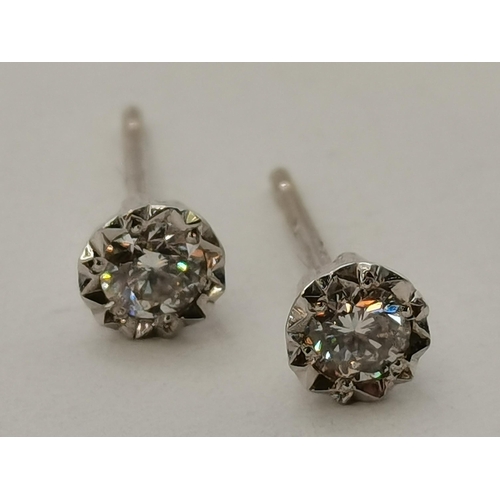 392 - A pair of 9 carat white gold solitaire diamond stud earrings, hallmarked, (no backs). 45mm diameter,... 